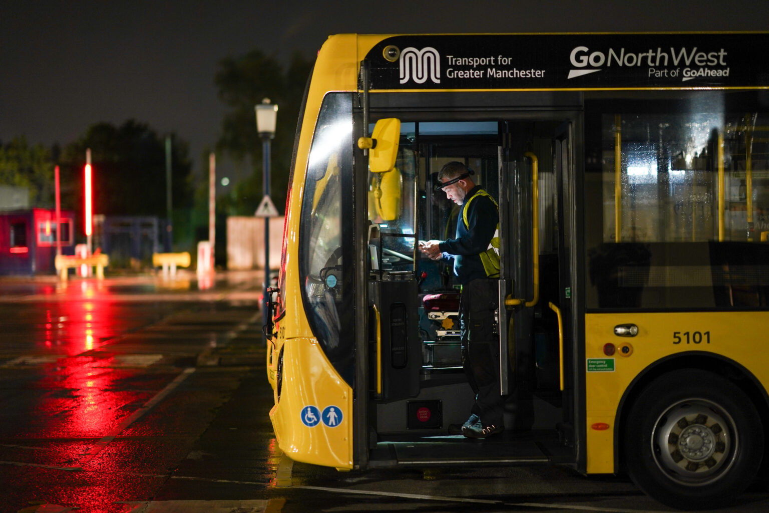 Yellow bus in a depot.